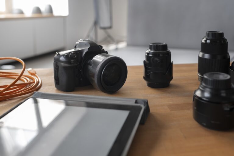 DSLR on table with lenses